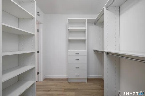 a view of walk in closet with empty racks
