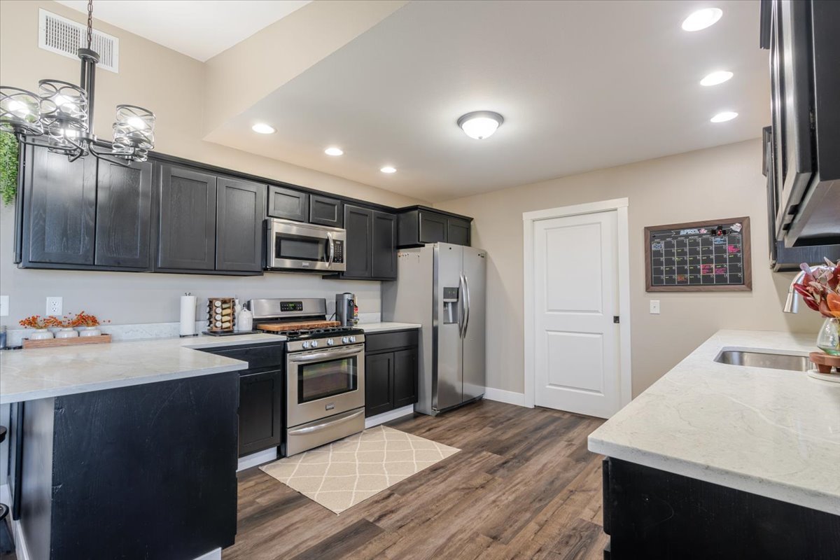 1388 East 2950 North Road Mansfield, IL 61854 - Photo 11 of 43 a kitchen with stainless steel appliances granite countertop a sink stove and refrigerator