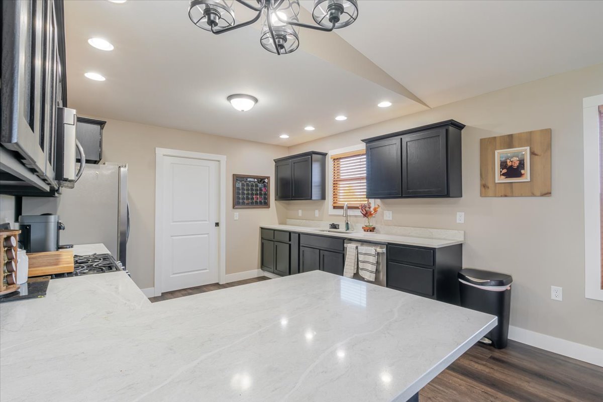 1388 East 2950 North Road Mansfield, IL 61854 - Photo 12 of 43 a large kitchen with a large counter top appliances and cabinets