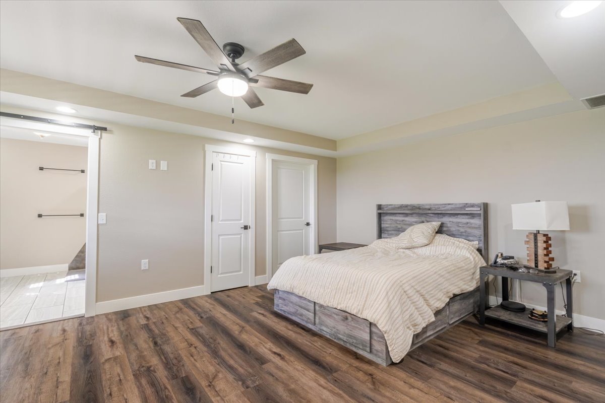 1388 East 2950 North Road Mansfield, IL 61854 - Photo 17 of 43 a bedroom with a large bed and a chandelier fan