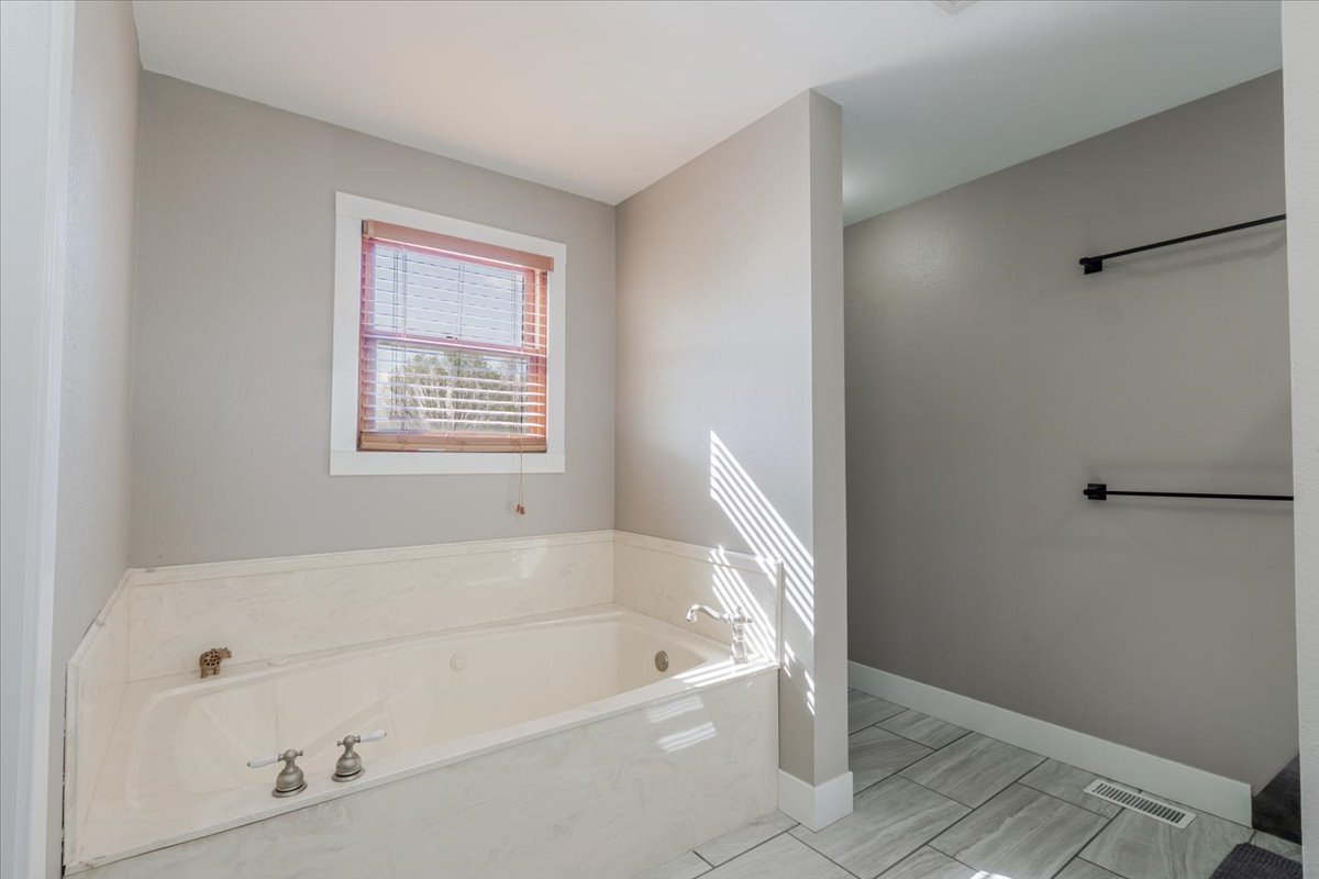 1388 East 2950 North Road Mansfield, IL 61854 - Photo 19 of 43 a white bath tub sitting next to a window