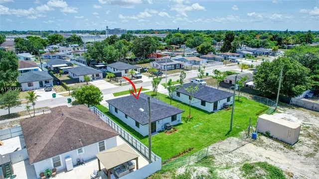 a view of a house with a garden and outdoor space
