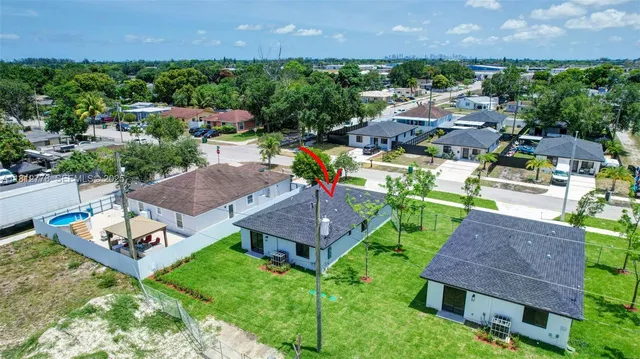 an aerial view of a house with garden space and street view