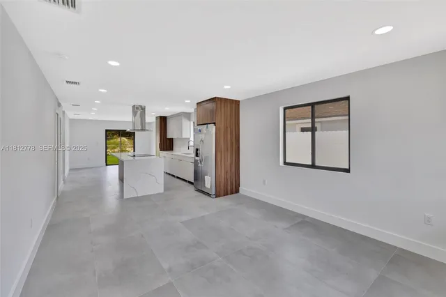 a view of a kitchen with refrigerator and a stove