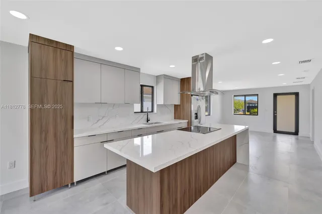 a spacious bathroom with a granite countertop sink a mirror and shower