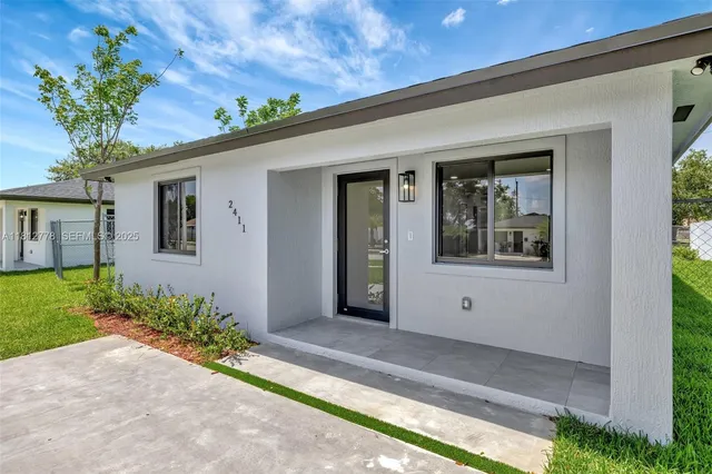 a view of a house with a flower garden