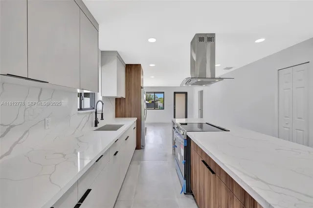 a kitchen with a stove a refrigerator and a sink
