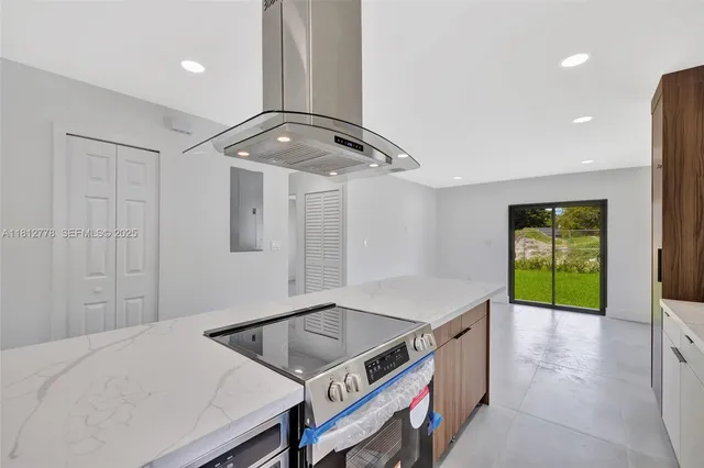 a large white kitchen with a sink stainless steel appliances and cabinets
