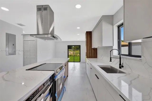 a kitchen with stainless steel appliances a refrigerator sink and microwave