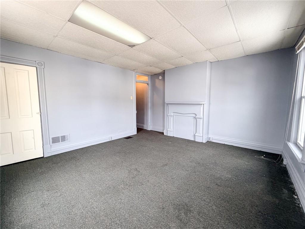217 13th Street, Unit 2 Beaver Falls, PA 15010 - Photo 3 of 9 an empty room with a empty space and windows