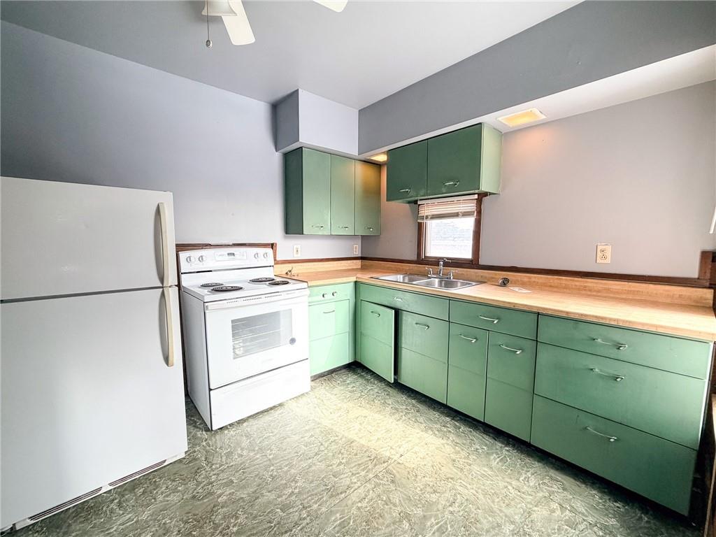 217 13th Street, Unit 2 Beaver Falls, PA 15010 - Photo 8 of 9 a kitchen with a refrigerator sink and cabinets