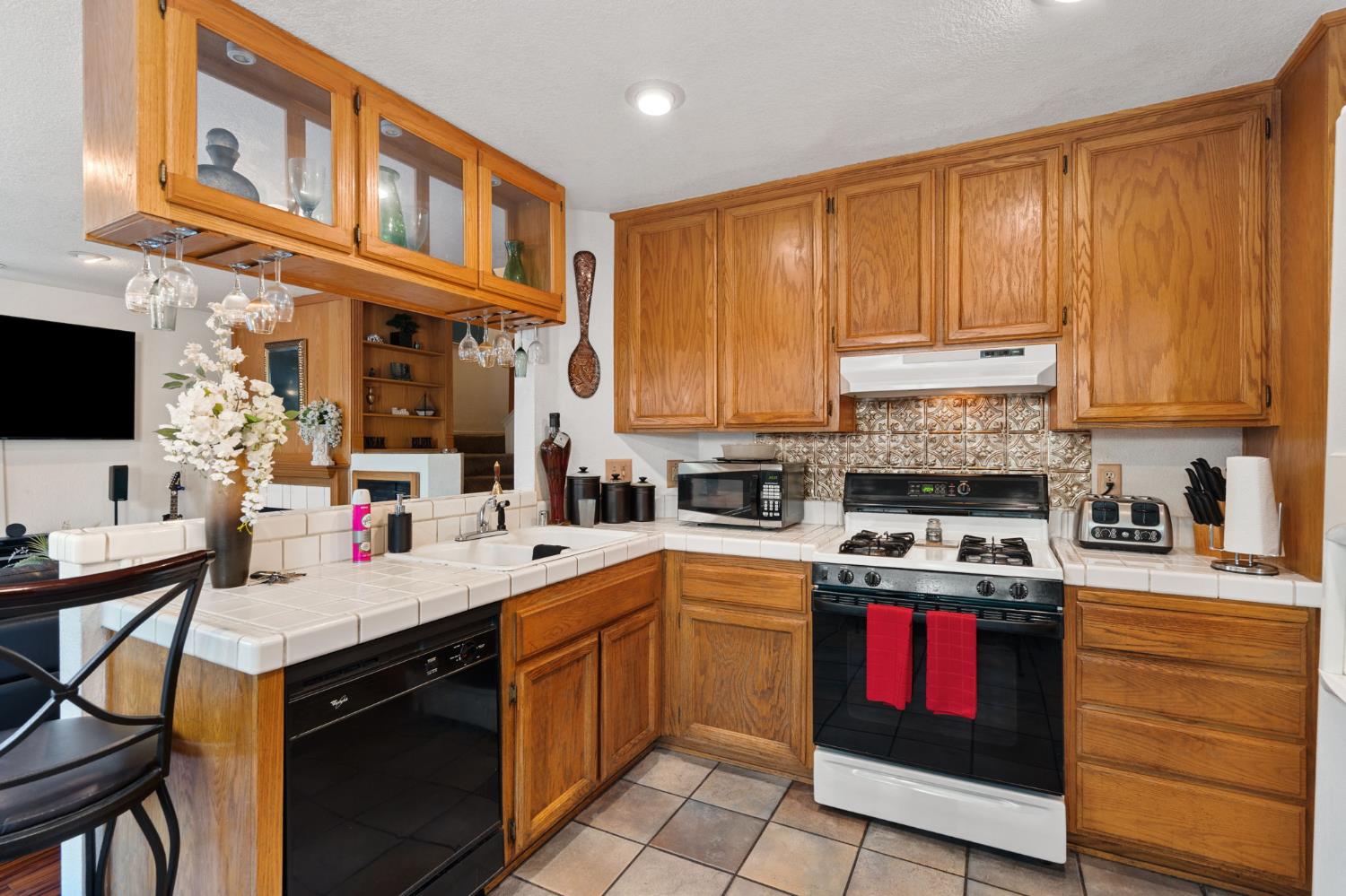 3941 Grey Livery Way Antelope, CA 95843 - Photo 10 of 28 a kitchen with a sink dishwasher a stove and a microwave oven with cabinets