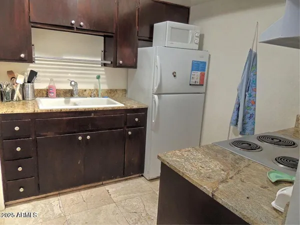 a kitchen with a sink stove and cabinets