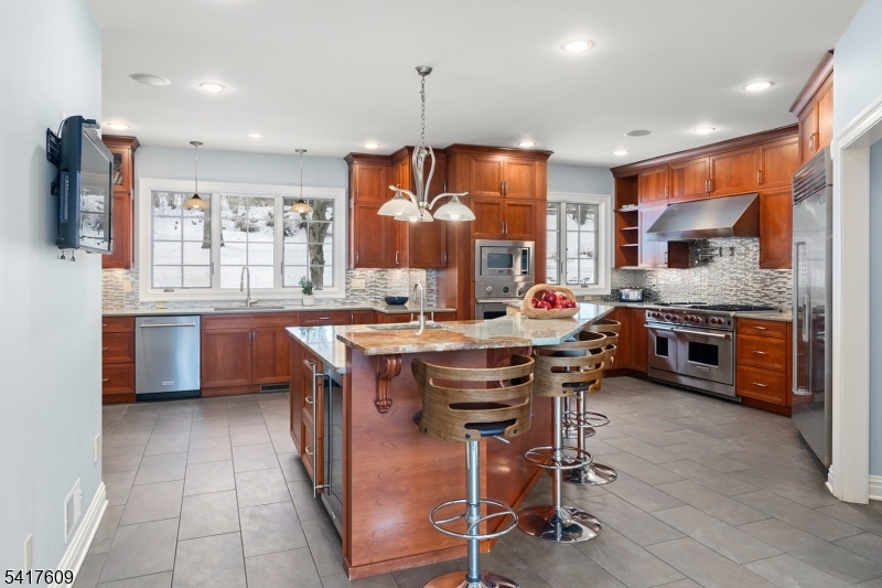 2 Cobblefield Road Mendham, NJ 07945 - Photo 11 of 50 a open kitchen with stainless steel appliances granite countertop a stove top oven a sink dishwasher a dining table and chairs with wooden floor