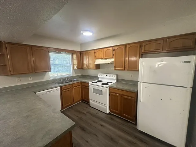 a kitchen with a white cabinets and white appliances