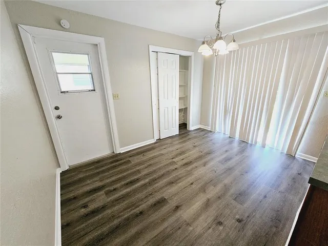 wooden floor in an empty room with a mirror
