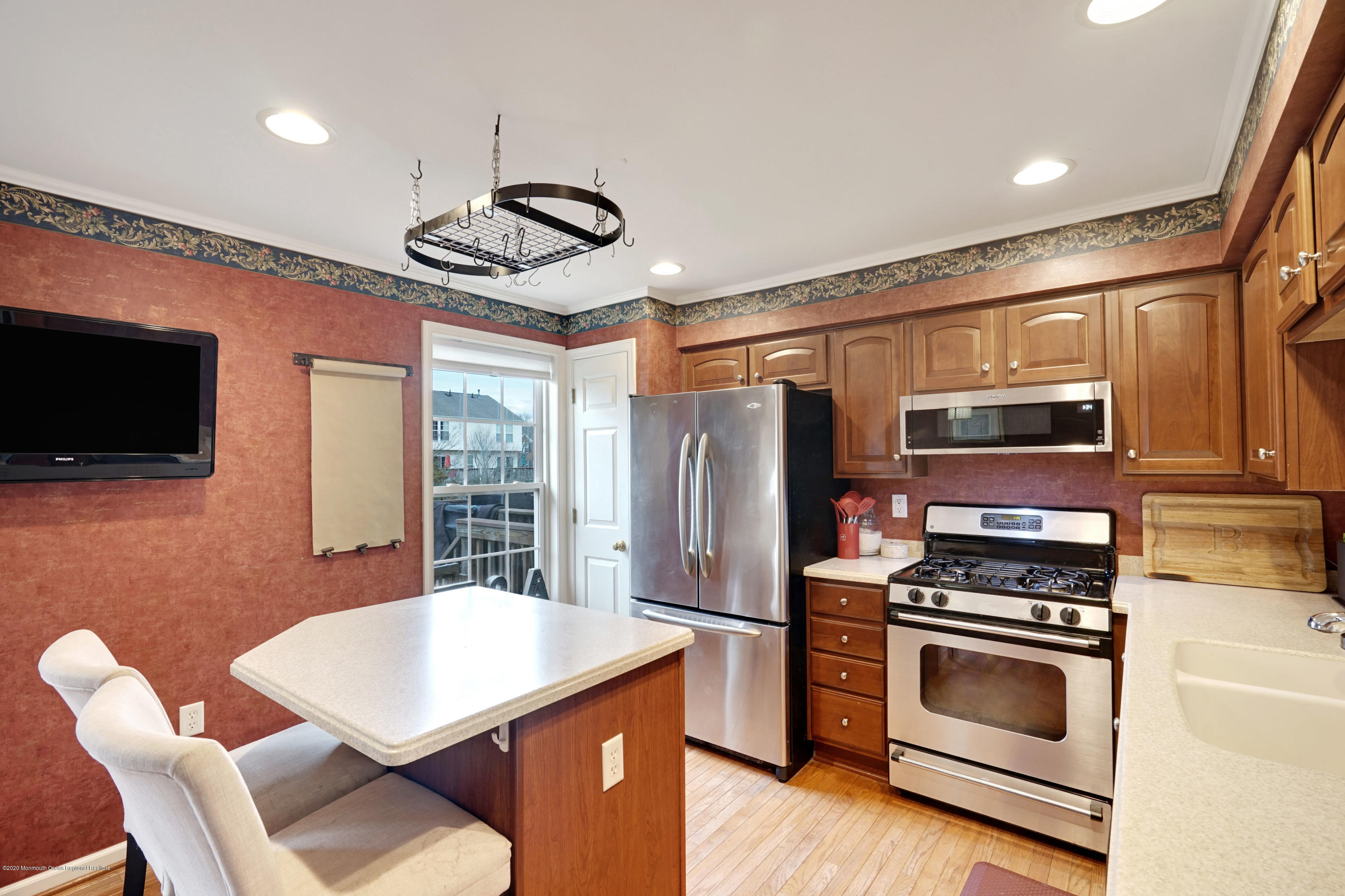 60 Saxton Road, Unit 87 Farmingdale, NJ 07727 - Photo 13 of 38 a kitchen with stainless steel appliances a stove a microwave and a refrigerator