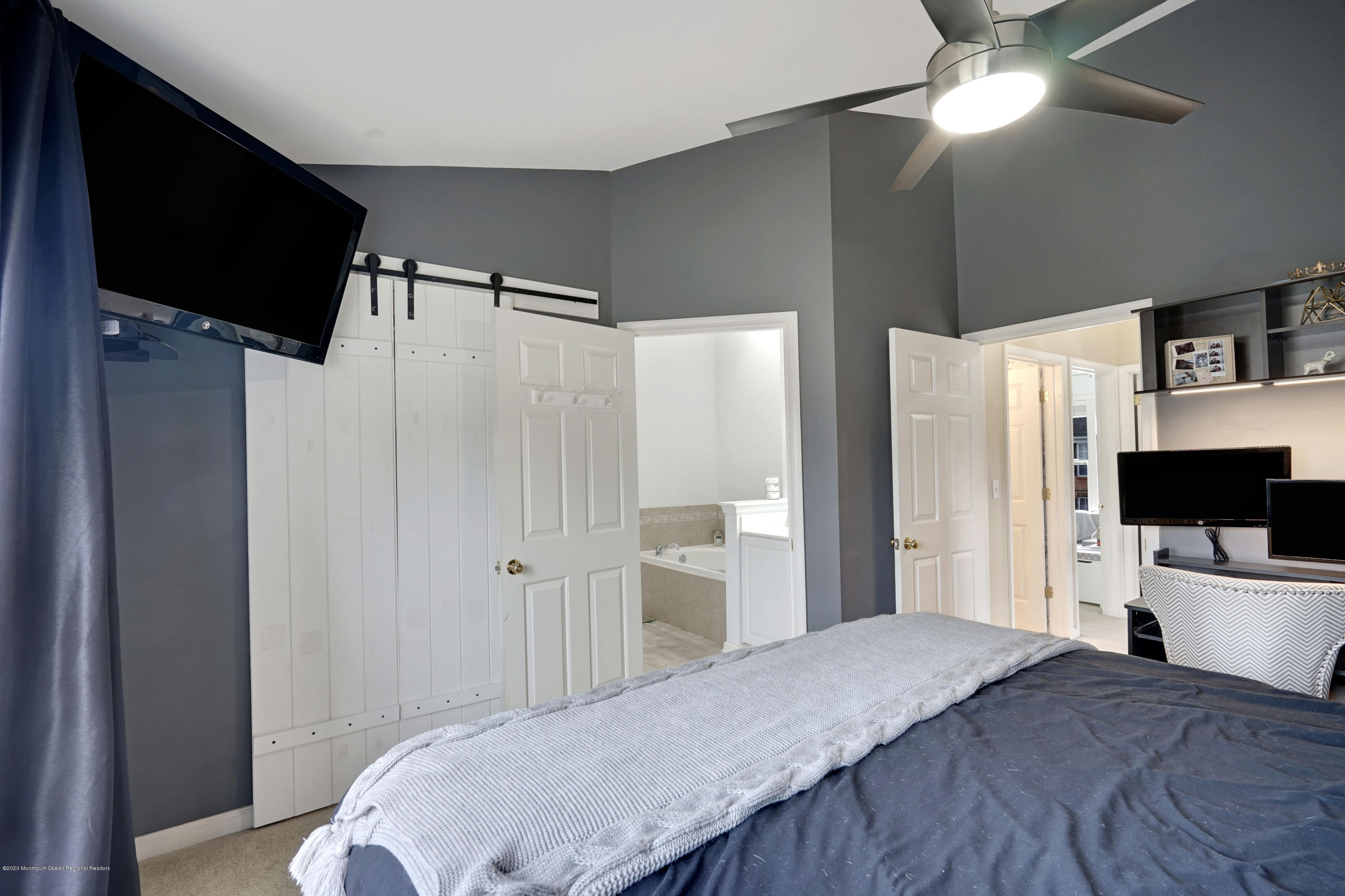 60 Saxton Road, Unit 87 Farmingdale, NJ 07727 - Photo 20 of 38 a bedroom with a bed and a flat screen tv