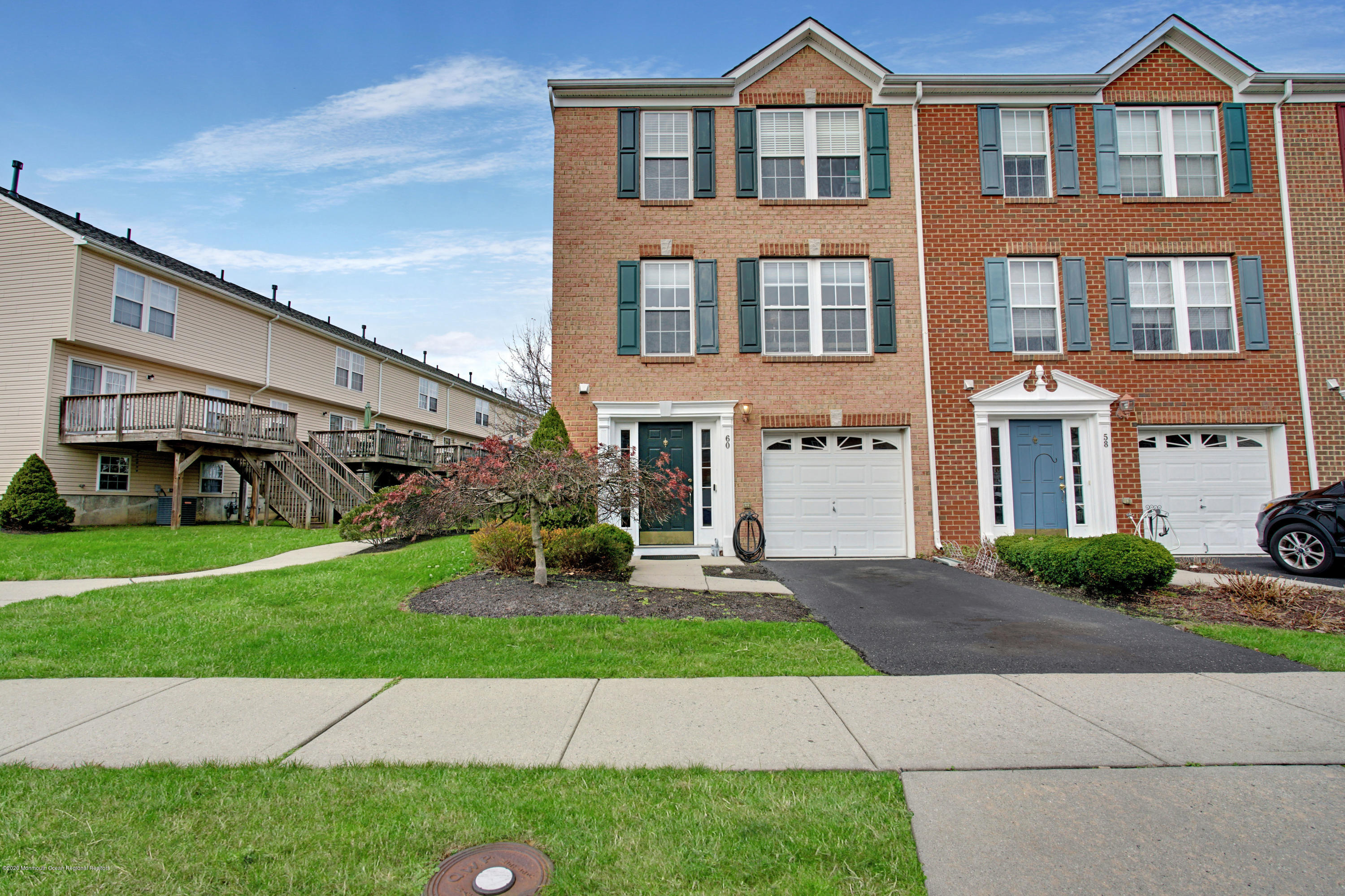60 Saxton Road, Unit 87 Farmingdale, NJ 07727 - Photo 3 of 38 a front view of a house with a yard and garage