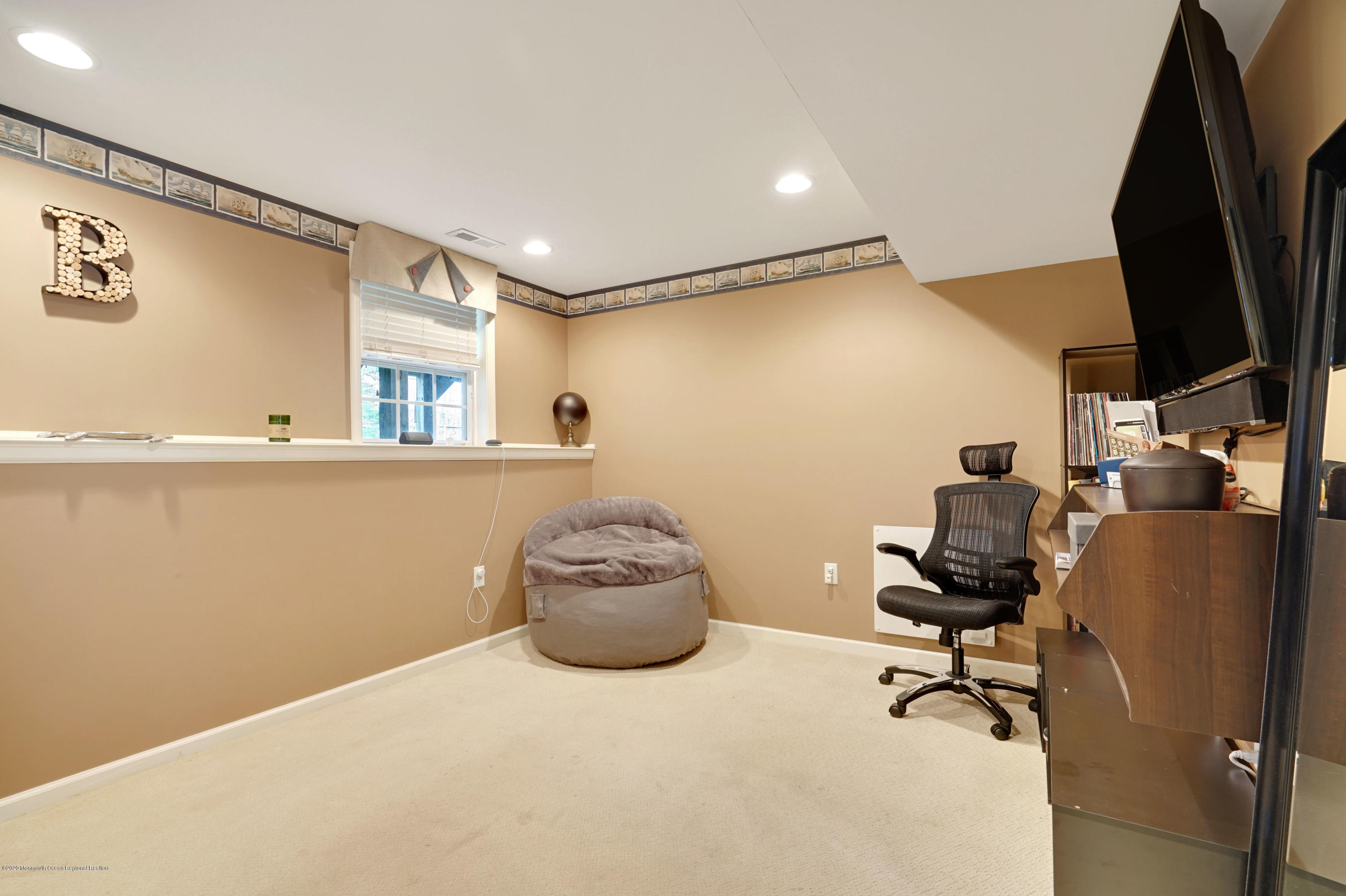 60 Saxton Road, Unit 87 Farmingdale, NJ 07727 - Photo 29 of 38 a room with furniture and a flat screen tv