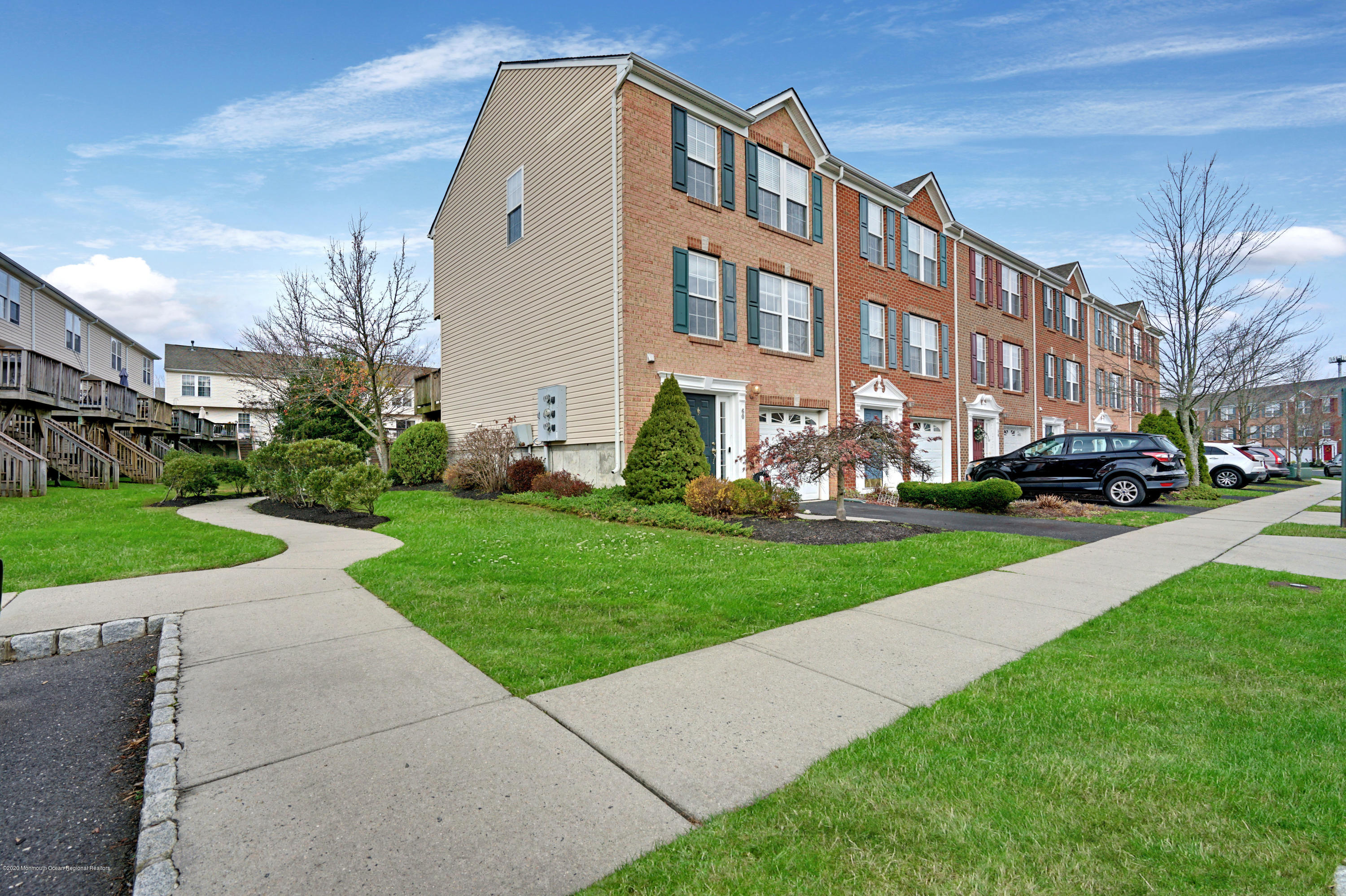 60 Saxton Road, Unit 87 Farmingdale, NJ 07727 - Photo 4 of 38 a front view of a building with garden