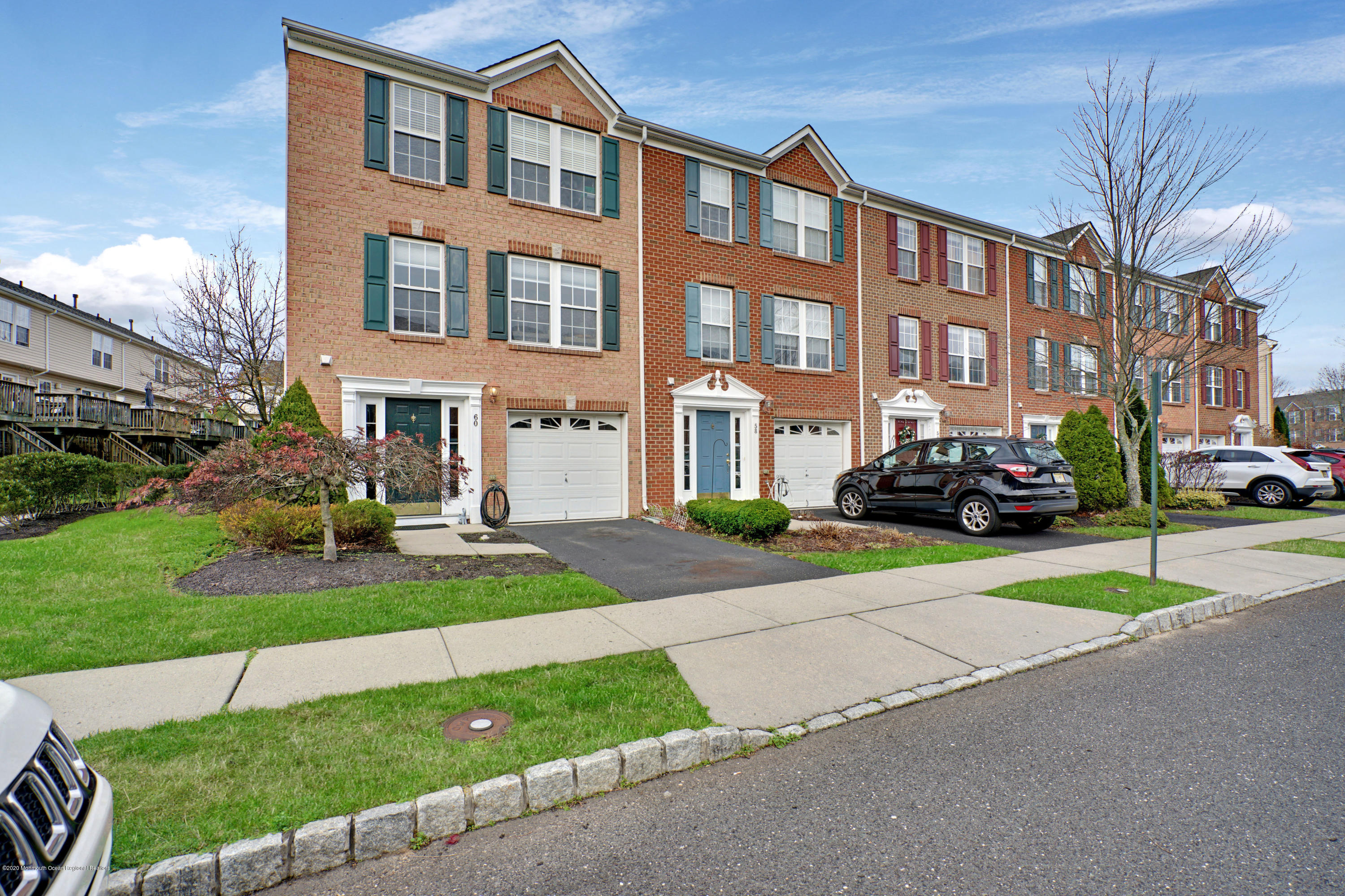 60 Saxton Road, Unit 87 Farmingdale, NJ 07727 - Photo 38 of 38 a view of a brick house with a yard next to a road