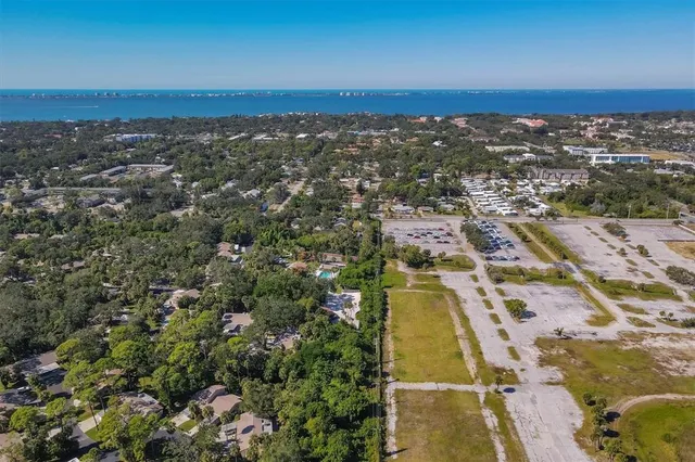a view of a swimming pool with a patio and a yard