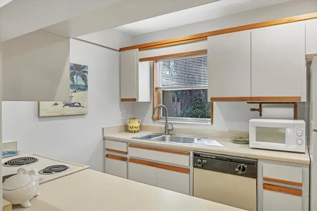 a kitchen with a sink cabinets and window