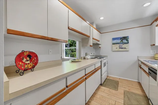 a kitchen with a sink and a stove top oven