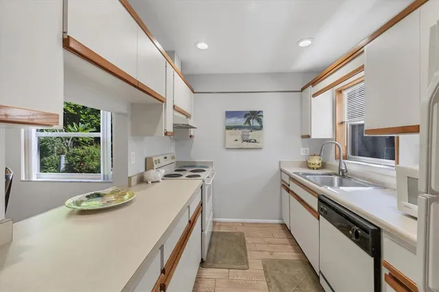 a kitchen with a sink stove and cabinets