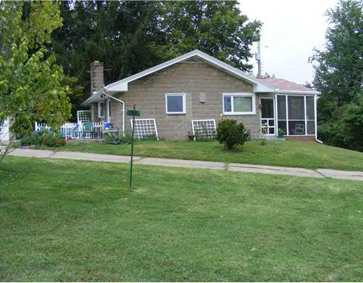 Exterior Back. The photo is taken from the side of the house.  You can see the screened in Front Porch for summer time pleasure. All newer windows too.
