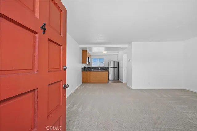 a view of a kitchen with a refrigerator and a stove