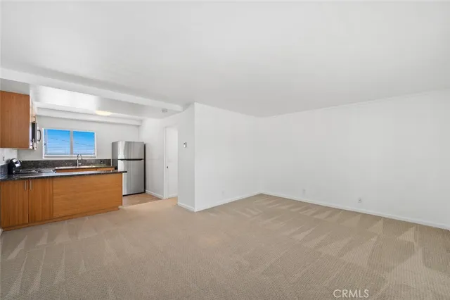 a kitchen with stainless steel appliances a refrigerator and a stove