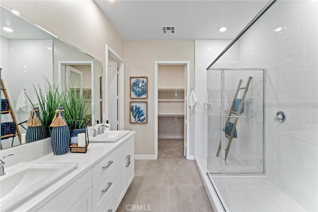 419 Transport Tustin, CA 92782 - Photo 26 of 58 a bathroom with a double vanity sink a mirror and shower