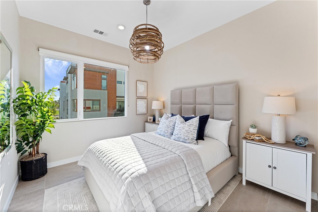419 Transport Tustin, CA 92782 - Photo 31 of 58 a bedroom with a large bed and a potted plant