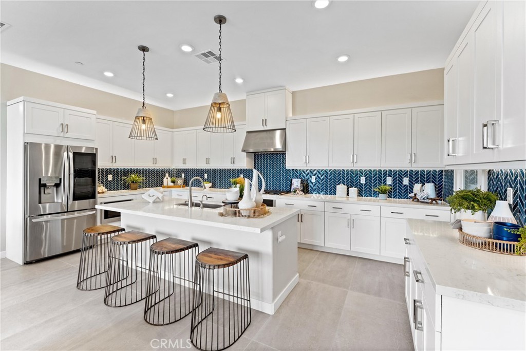 419 Transport Tustin, CA 92782 - Photo 4 of 58 a kitchen with a sink a center island stainless steel appliances and cabinets