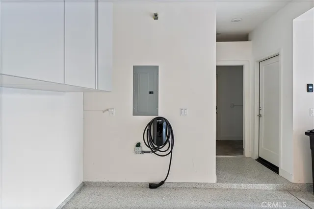 a view of a swimming pool with lounge chairs in front of house