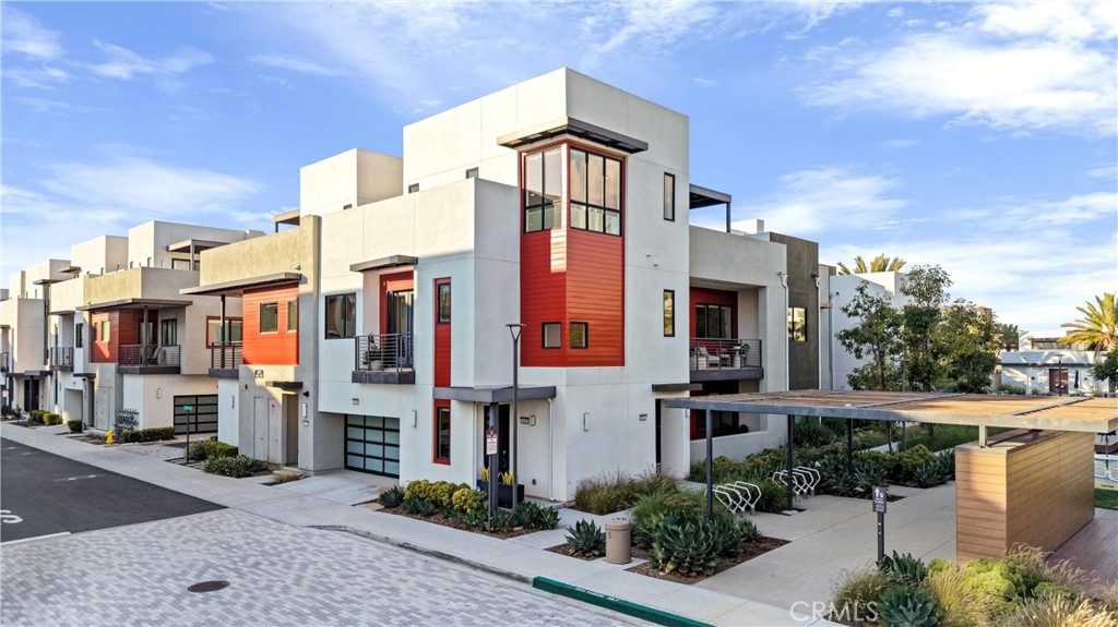419 Transport Tustin, CA 92782 - Photo 45 of 58 a front view of a residential apartment building with a yard