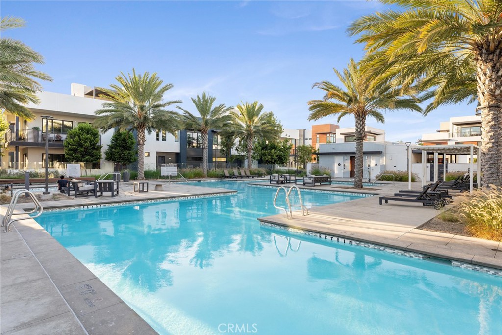 419 Transport Tustin, CA 92782 - Photo 55 of 58 a view of a swimming pool with a lounge chair and palm trees