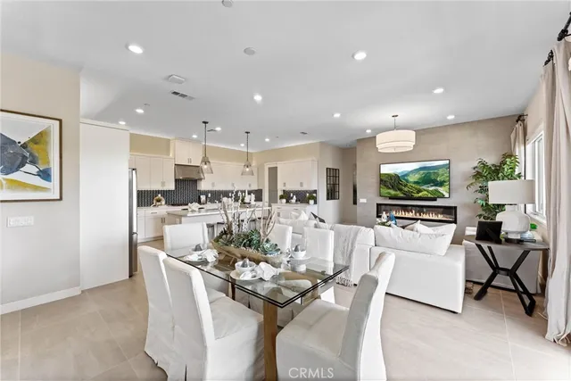 a living room with furniture a large window and a potted plant