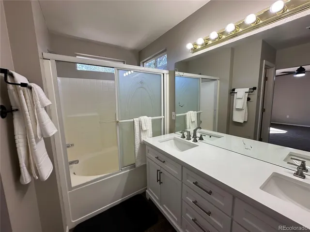 a bathroom with a double vanity sink mirror double and shower