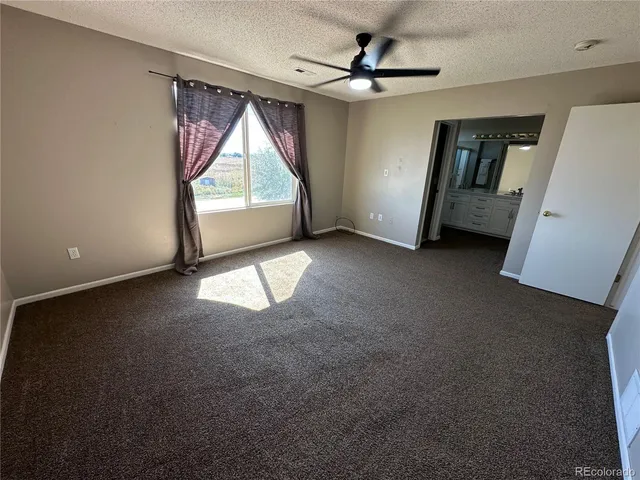 a view of empty room with ceiling fan