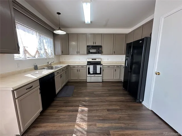a kitchen with a sink stove and refrigerator