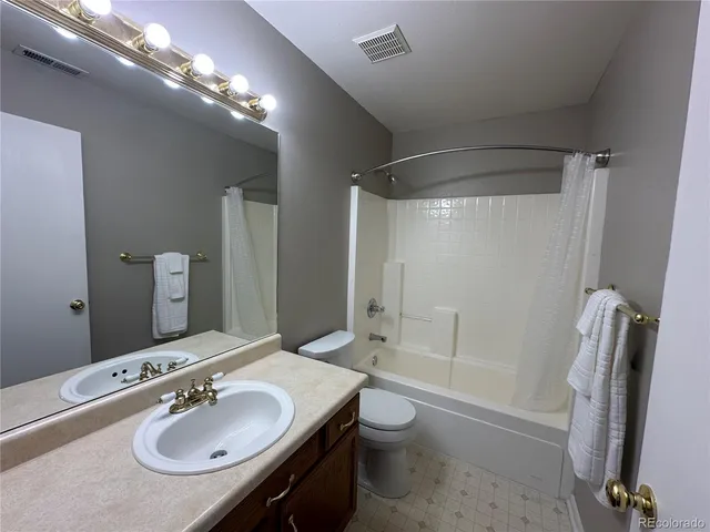a bathroom with a sink double vanity granite tub and a mirror