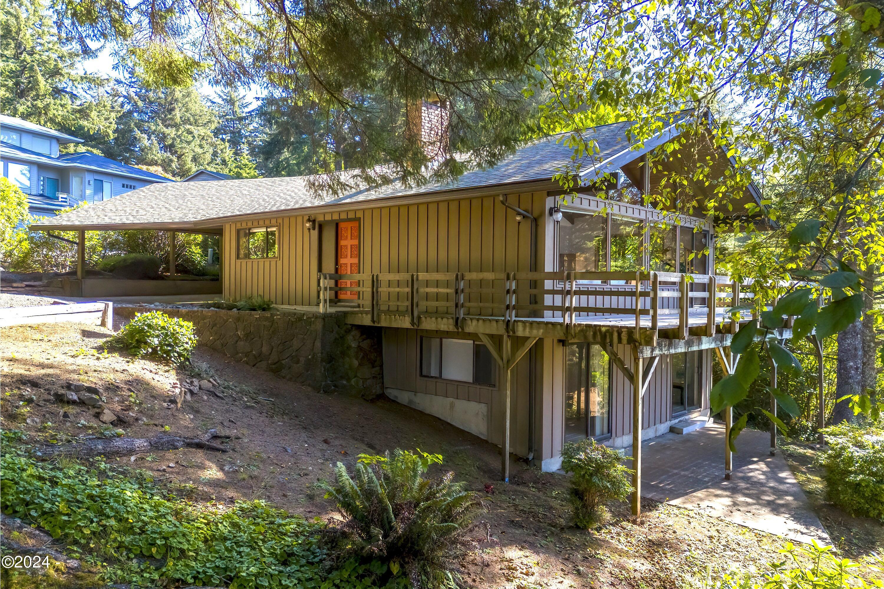 114 Ridge Crest Road Gleneden Beach, OR 97388 - Photo 8 of 40 a view of a house with a yard