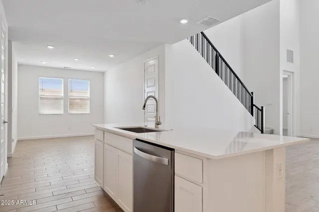 a kitchen with a sink stainless steel appliances and cabinets