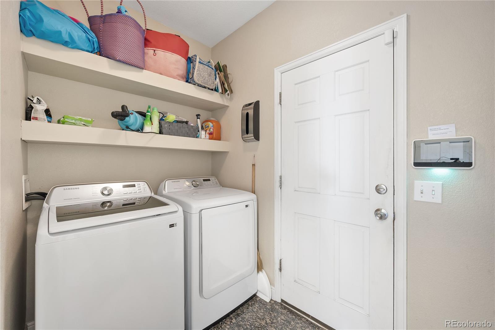 1201 Riddlewood Road Highlands Ranch, CO 80129 - Photo 15 of 36 a utility room with dryer and washer