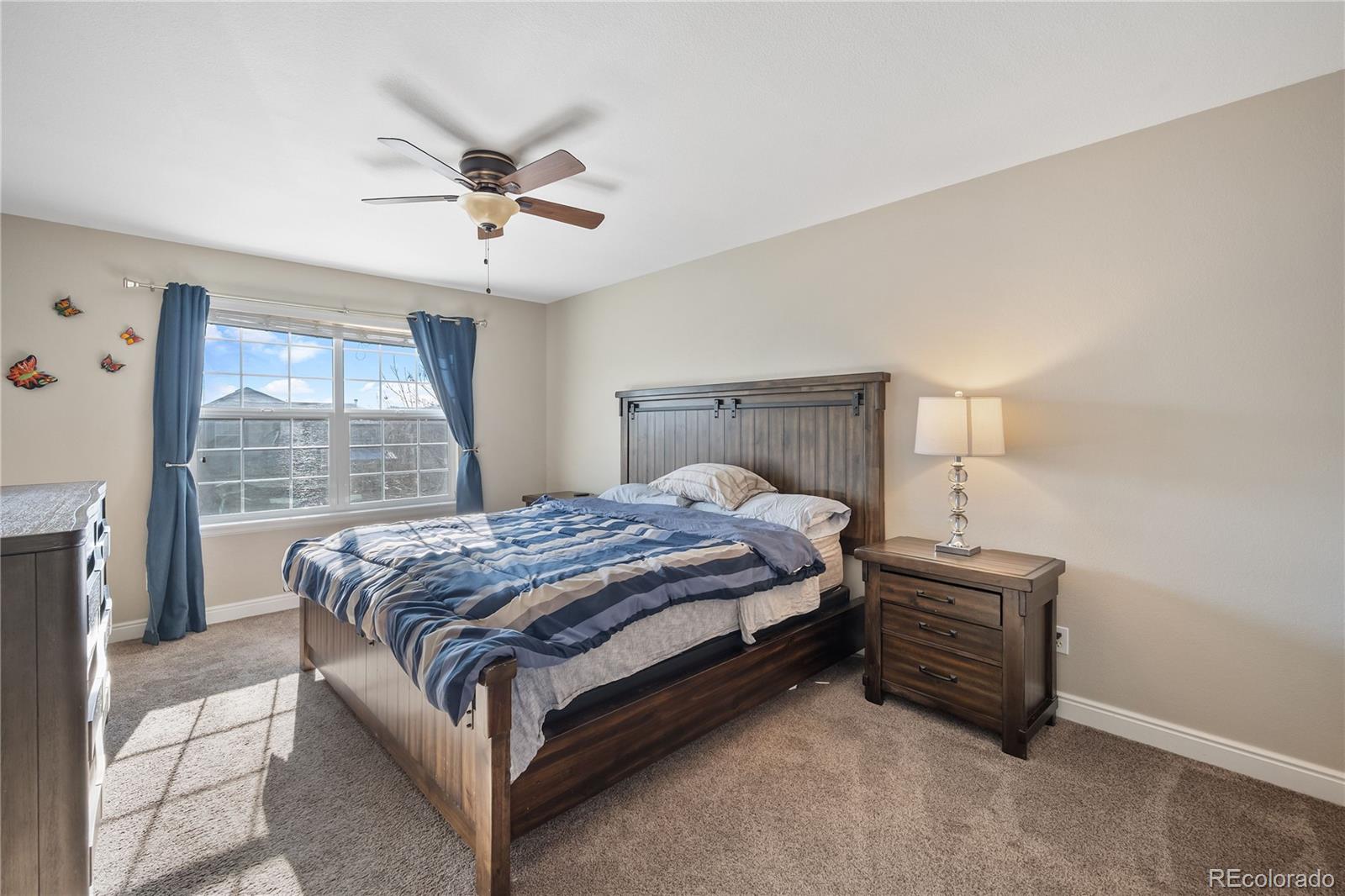 1201 Riddlewood Road Highlands Ranch, CO 80129 - Photo 16 of 36 a bedroom with a bed and window