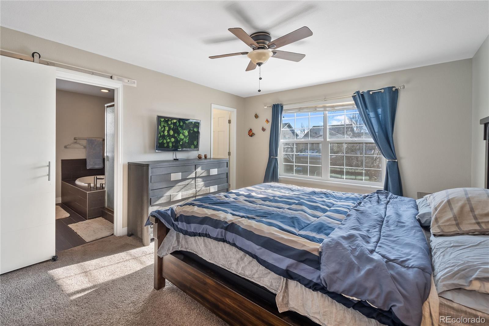 1201 Riddlewood Road Highlands Ranch, CO 80129 - Photo 19 of 36 a bed sitting in a bedroom next to a window