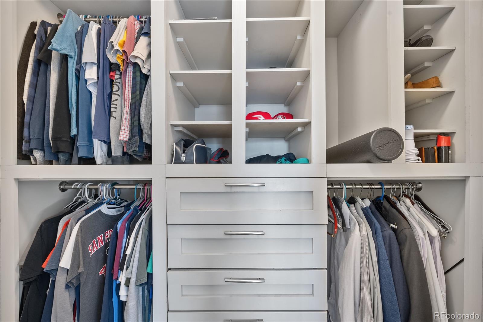 1201 Riddlewood Road Highlands Ranch, CO 80129 - Photo 20 of 36 a view of walk in closet with clothes and shoes